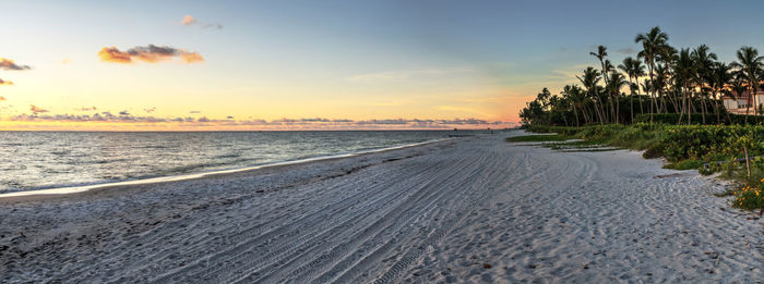 Dilapidated ruins of a pier on port royal beach at sunset in naples, florida