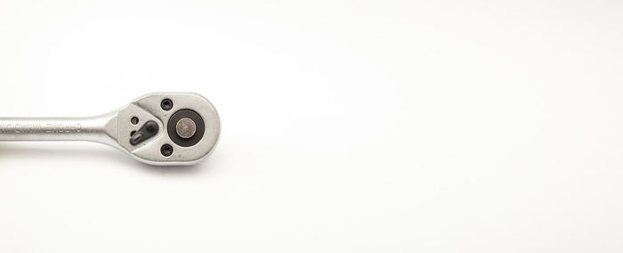 Close-up of key against white background