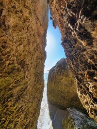Rock formations by sea against sky