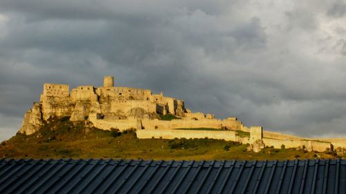 Low angle view of building against cloudy sky