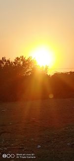 Scenic view of field against sky during sunset