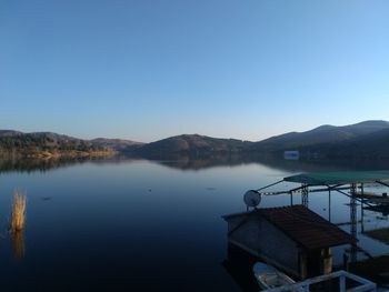 Scenic view of lake against clear blue sky