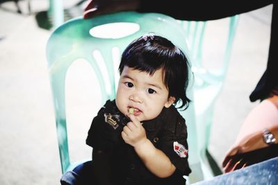 Portrait of cute girl sitting outdoors