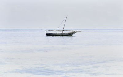 Sailboat in sea against sky