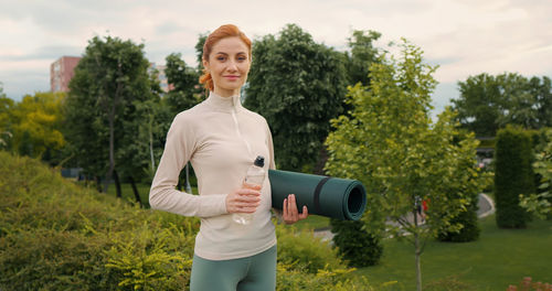 Tired fit woman resting, catching breath after active crossfit training or jogging. 