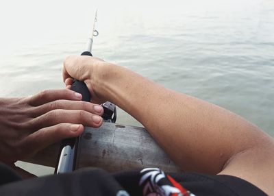 Low section of man holding water