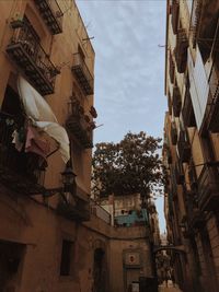 Low angle view of buildings in city against sky
