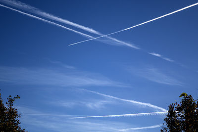 Low angle view of vapor trails in sky