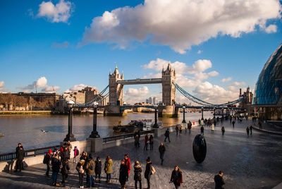 Group of people on bridge over river