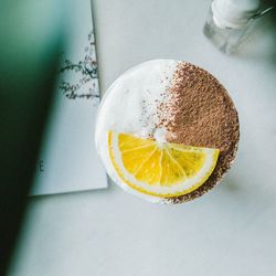 Directly above shot of drink with fruit slice on table