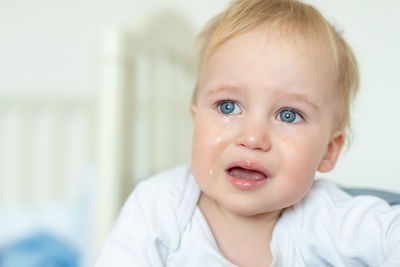 Cute baby boy looking away while crying