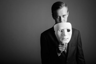 Portrait of man wearing mask against white background