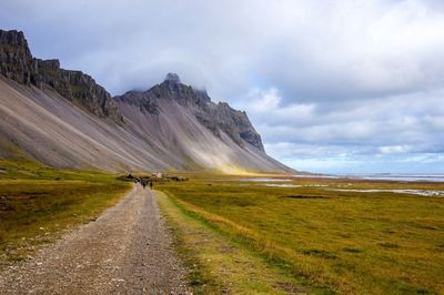 Road amidst landscape against sky