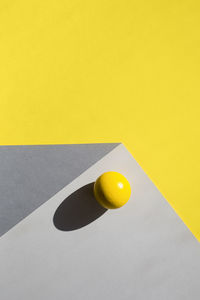 High angle view of yellow ball on table