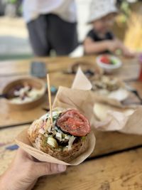 Cropped hand of person holding food