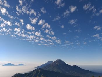 Scenic view of mountains against cloudy sky