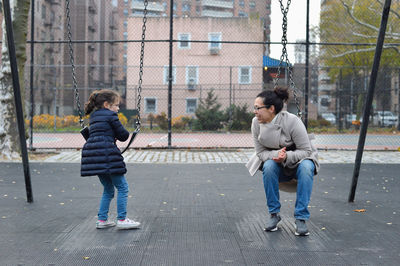 Mom and daughter spending time at the swing