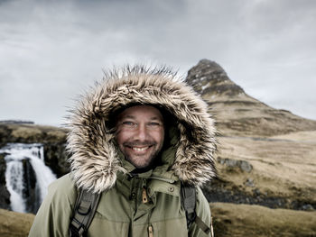 Smiling man wearing hood