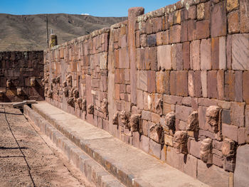 Stone heads in a wall in la paz, bolivia