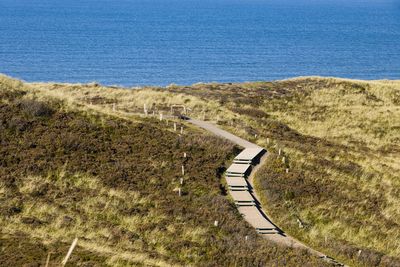 High angle view of land and sea against sky