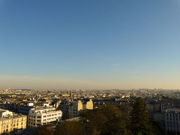 High angle view of buildings against blue sky