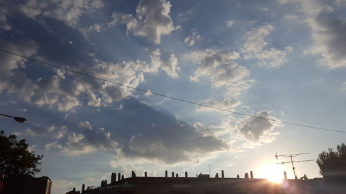 Low angle view of silhouette trees against sky