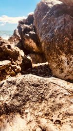 Close-up of rock formation on beach against sky