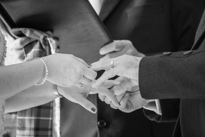 Midsection of couple holding hands