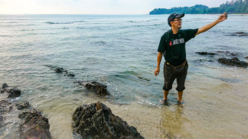 Man taking selfie from mobile phone at beach