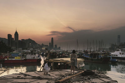 Rear view of females standing on boat against sky