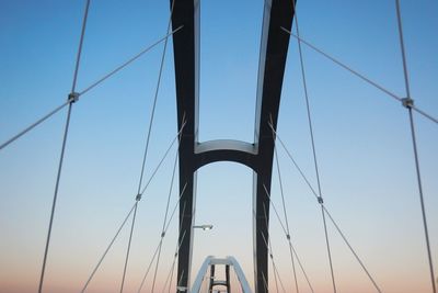 Low angle view of suspension bridge against sky