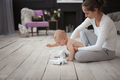 Side view of boy playing with toy on floor