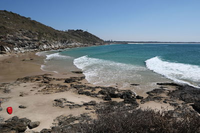 Scenic view of beach against clear sky