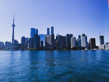 Modern buildings in city against clear sky