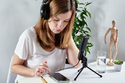 Woman listening online course in headphones, distance education