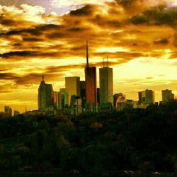 Skyscrapers in city at sunset