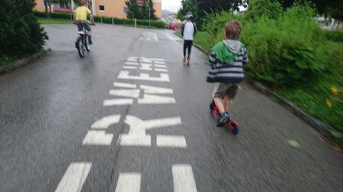 Blurred motion of people walking on road