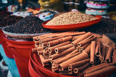 Pile of cinnamon sticks, black pepper and other spices at bazaar