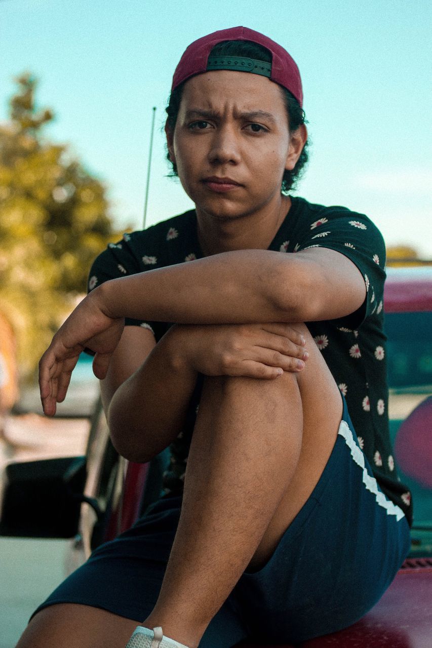 one person, real people, front view, leisure activity, focus on foreground, lifestyles, looking at camera, portrait, day, strength, outdoors, sport, childhood, young adult, sky, headwear, young women, close-up, people