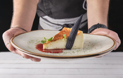 Midsection of man holding food