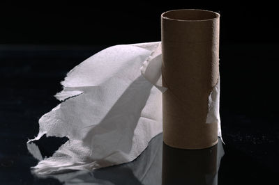 Close-up of toilet paper against black background