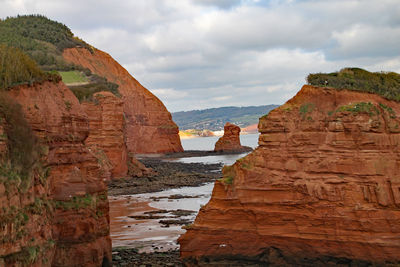 View of rock formations against cloudy sky