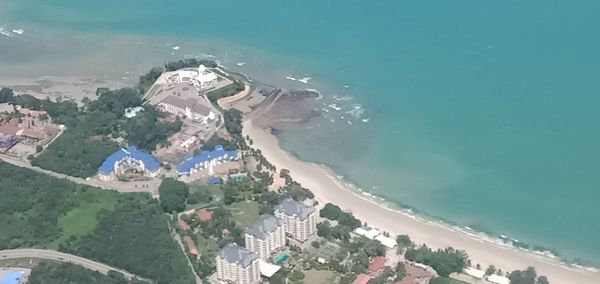 High angle view of buildings by sea against sky