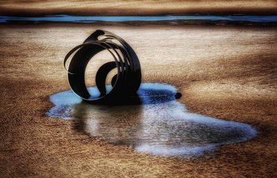 Close-up of water on beach against sky