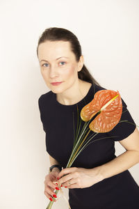 Young beauty woman holding calla lily flower isolated on white background. beautiful businesswoman