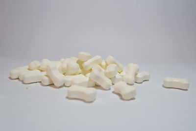 High angle view of candies on table against white background