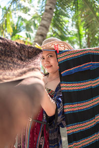 Rear view of woman standing in hat