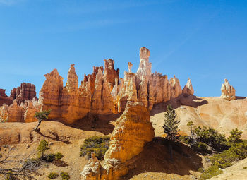 View of rock formations against blue sky