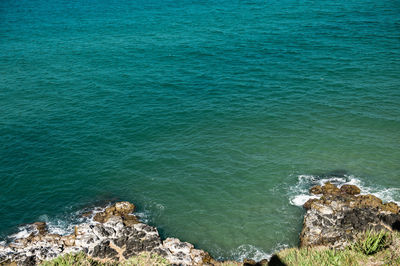 High angle view of rocks on sea
