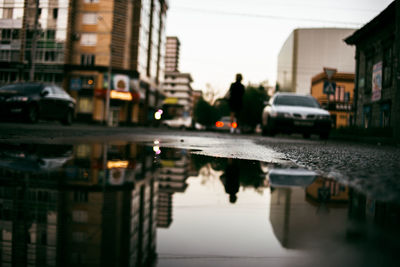 Close-up of cars on street in city